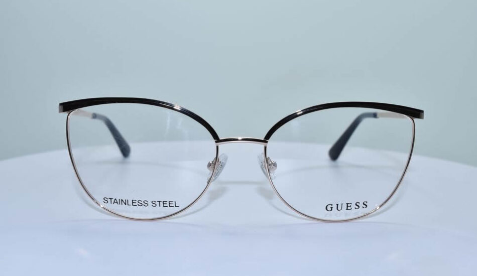 thin gold and black stainless steel framed GUESS glasses