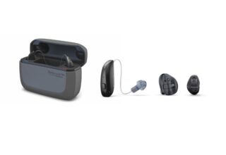 Hearing aids with an open charging case and three ear pieces laid out in a row, from left to right: case, behind‑the‑ear model, and two ear tips.