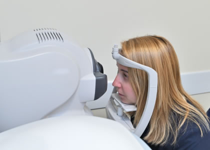 Woman having an OCT scan performed