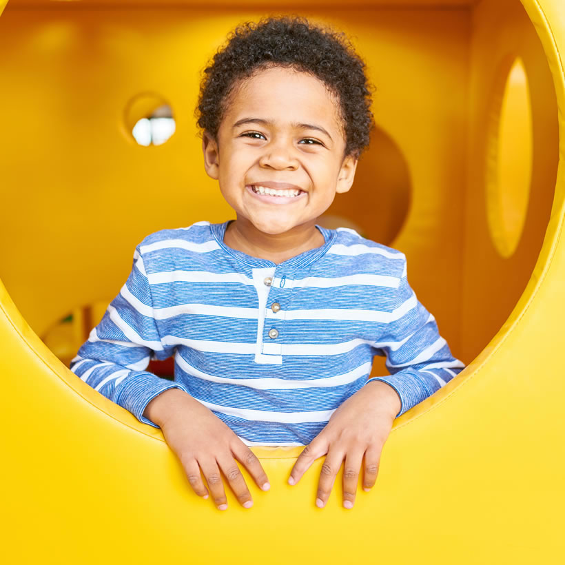 Small child playing in a climbing frame
