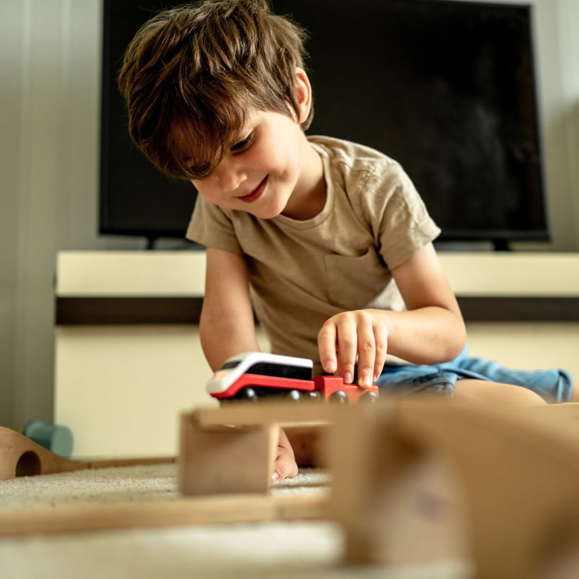 Small boy playing with toy trains