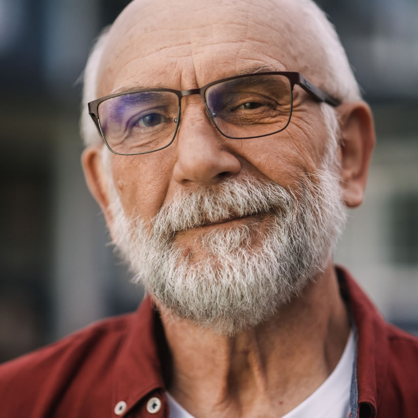 Older gentleman with grey hair wearing glasses