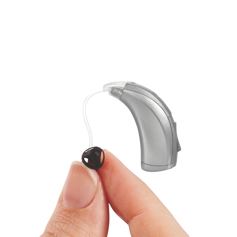 Hand holding up a BTE hearing aid
