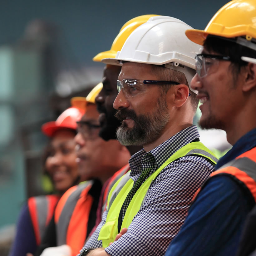 Several men in high vis jackets and hardhats