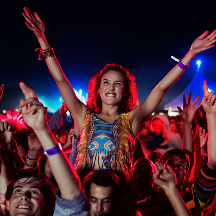 Woman up on mans shoulders at a rave