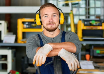 Man in factory wearing ear protection