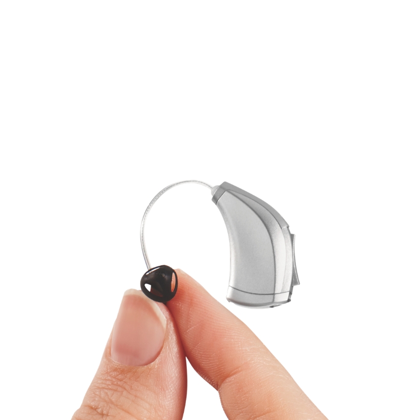 Hand holding up a RIC hearing aid