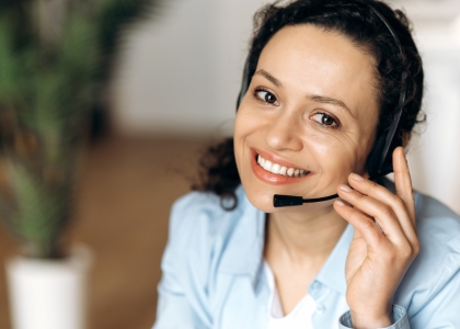 Woman smiling while wearing headset
