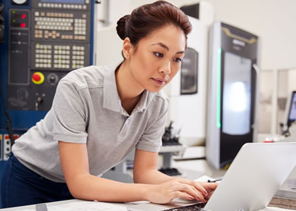 Woman in a lab looking at a laptop