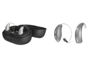 Pair of modern behind-the-ear (BTE) hearing aids with a charging case and charging cradle