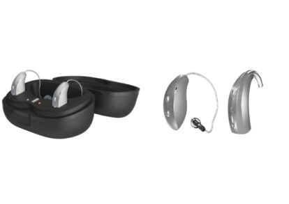 Pair of modern behind-the-ear (BTE) hearing aids with a charging case and charging cradle