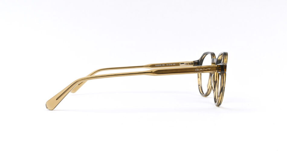 Gold-framed eyeglasses in side view with GANT logo on the temple on a white background