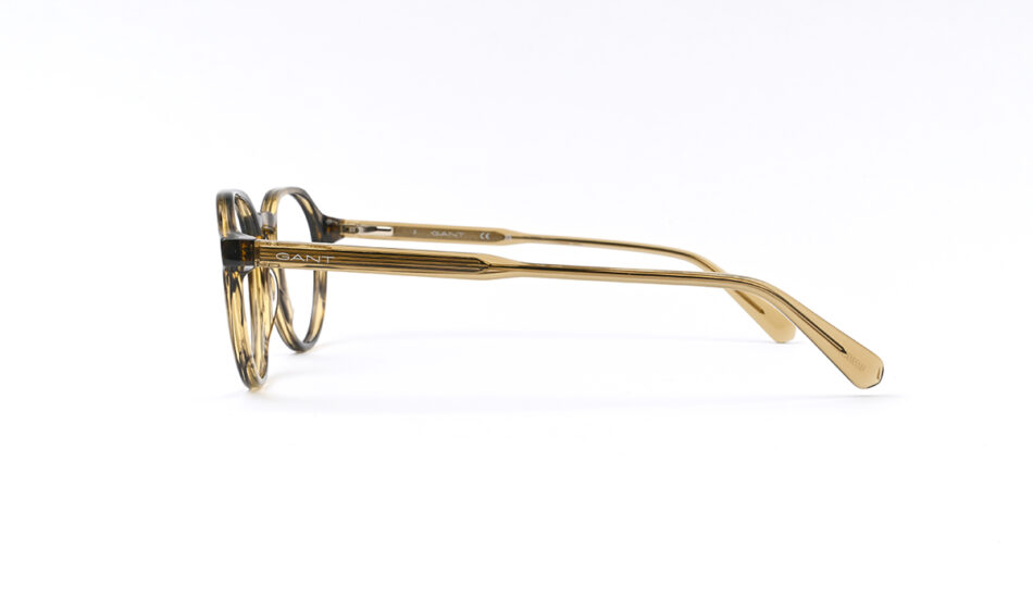 Side view of gold-tinted, round eyeglasses with thin temples and GANT branding on the temple edge, minimalistic style.