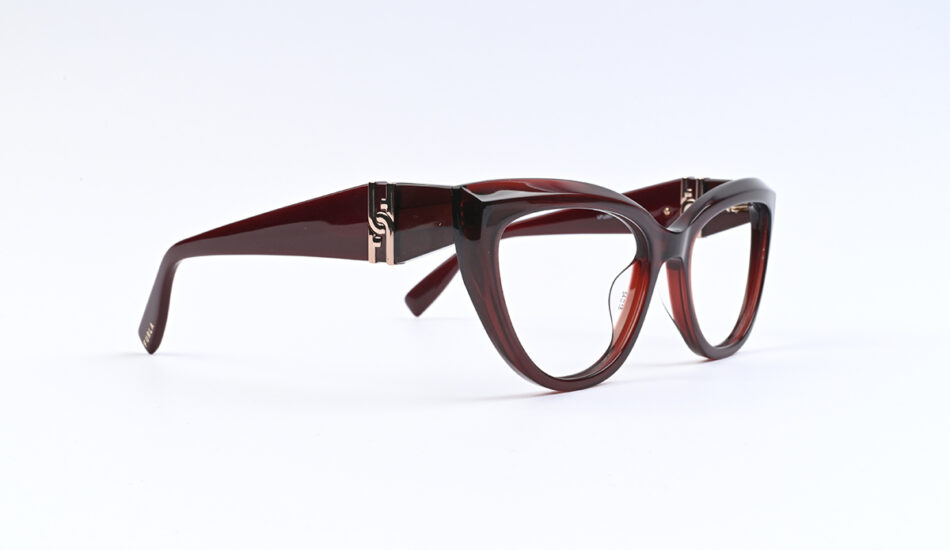 Burgundy oversized eyeglasses with clear lenses photographed on a white background, stylish frame detail visible on temples.