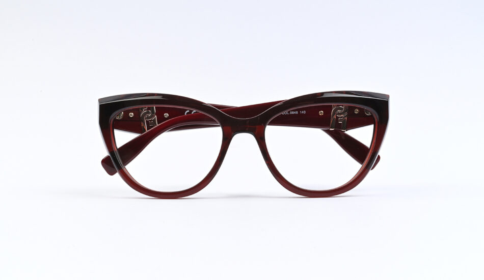 Red cat-eye eyeglasses with clear lenses on a white background.