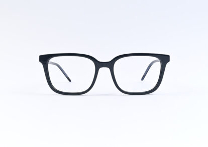 Black rectangular eyeglasses resting on a white surface.