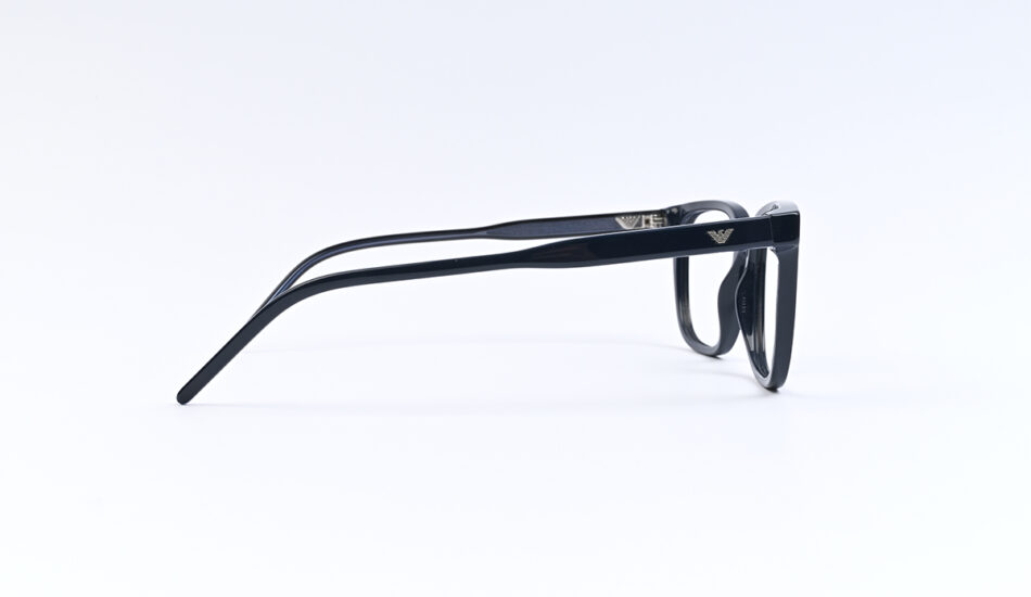 Side view of black plastic eyeglasses with an Armani eagle logo on the temple, on a white background.