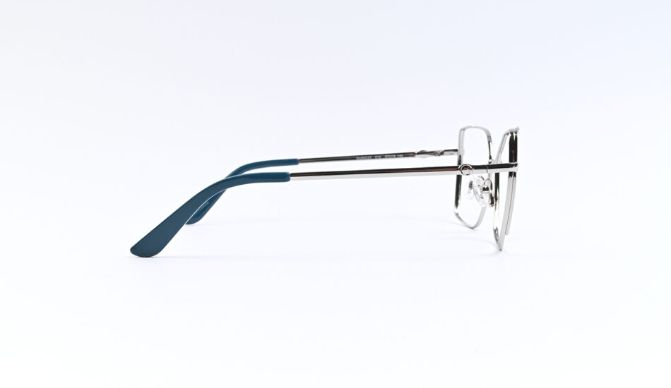 Side view of metal eyeglasses with blue temple tips resting on a white surface, profile shot.