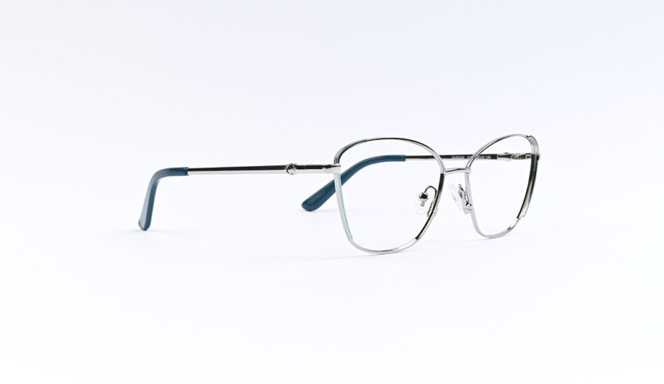 Metal-r framed eyeglasses with blue temple tips resting on a white surface, viewed from the side.