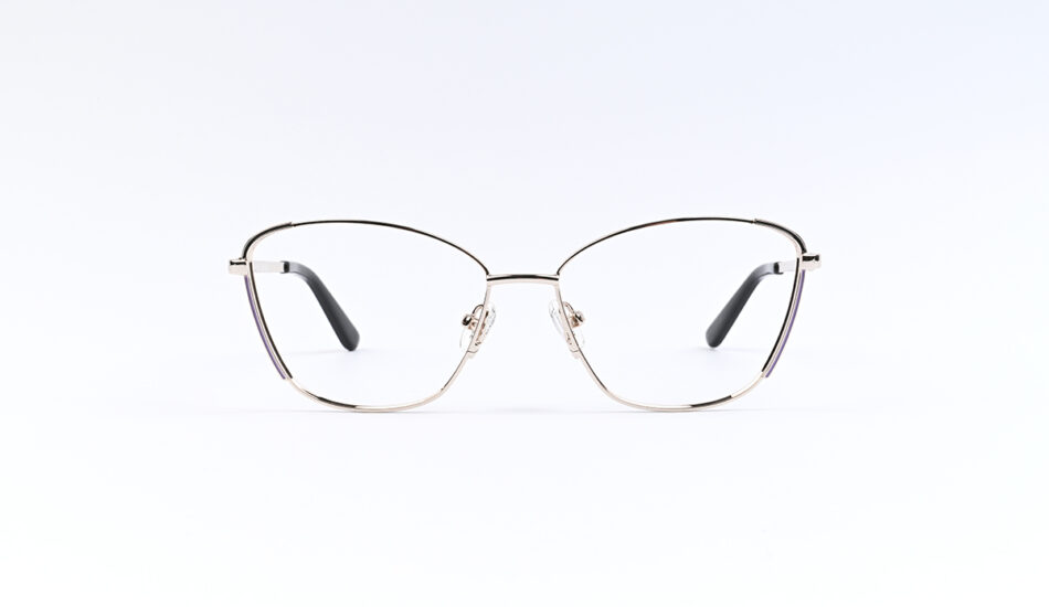Thin metal-rimmed eyeglasses with adjustable nose pads on a white background, resting on a flat surface, forward-facing