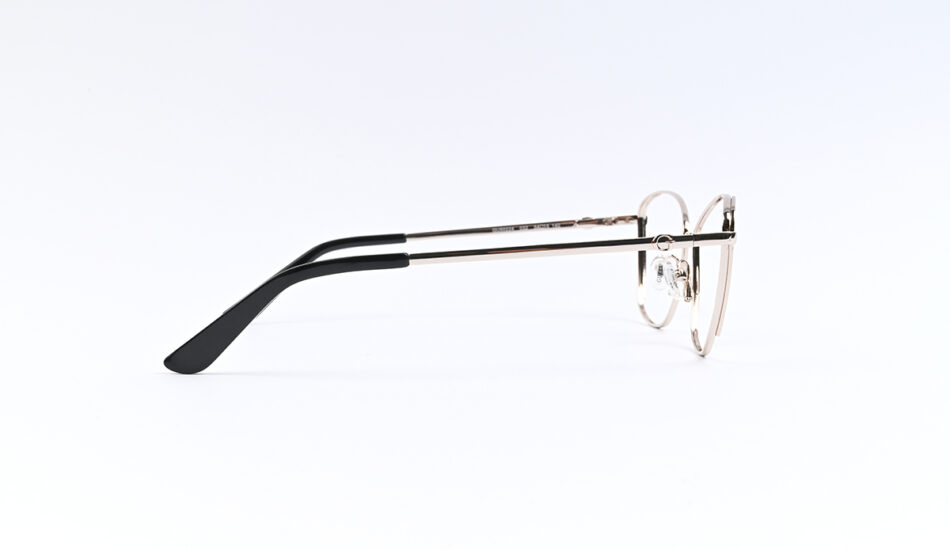 Side view of round metal-frame eyeglasses with black plastic temple tips on a white background, lying on a surface.